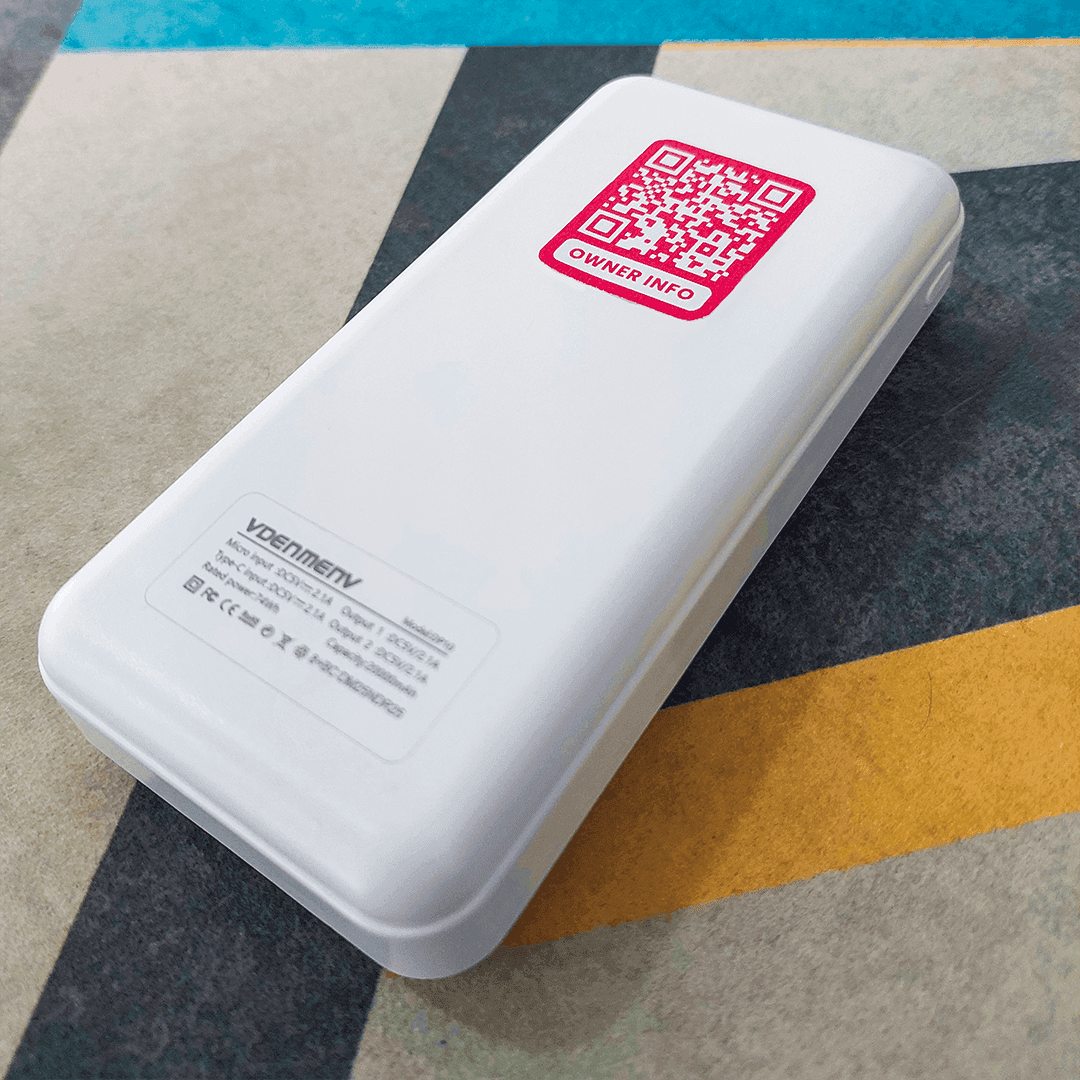 Power bank with a FindMe QR sticker attached for easy recovery